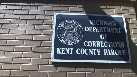 Michigan-Department-of-Corrections-Kent-County-sign-in-Grand-Rapids,-Michigan-with-video-panning-right-to-left