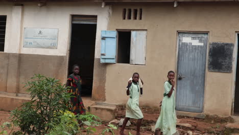 Three-Female-Students-Walking-Around-A-Rural-African-School-In-Uganda,-Africa