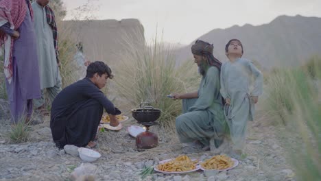 Father-preparing-the-feast-for-Iftar-In-Ramadan-in-the-open-sky-on-a-portable-cooker-making-fried-chips-in-Khusdar-Balochistan