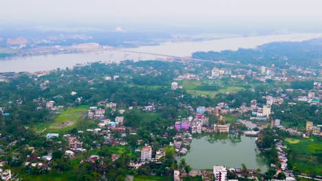 Rupatoli,-barisal,-bangladesh,-showing-the-dapdapia-bridge-over-the-kirtankhola-river-in-the-distance,-aerial-view