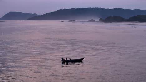 Fisherman's-Traditional-boat-at-a-deserted-beach-of-lombok-near-surf-spot-scar-reef-on-Sumbawa,-Indonesia-at-dusk