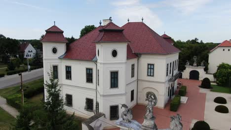 Closeup-shot-aerial-fly-street-around-castle-of-Hajos-Hungary-green-neighborhood