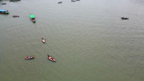 Passenger-Boats-At-Buriganga-River-In-Dhaka,-Bangladesh---Aerial-Drone-Shot