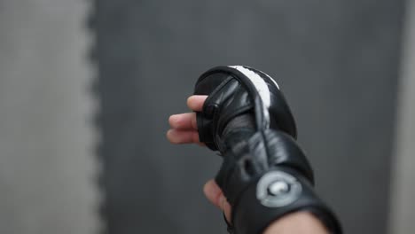 Vertical-shot-of-couple-hold-hands-after-MMA-sparring-session,-Czechia