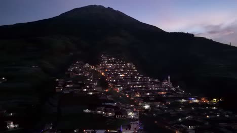 Amazing-view-of-village-on-the-slope-of-mountain-at-night-with-slightly-foggy-weather