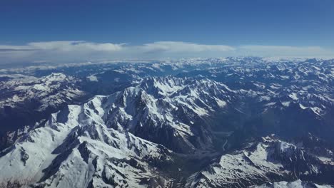 Elevated-aerial-view-of-Mont-Blanc-summit-in-The-Alps,-shot-from-an-airplane-cockpit-flying-northbound-at-8000m-high