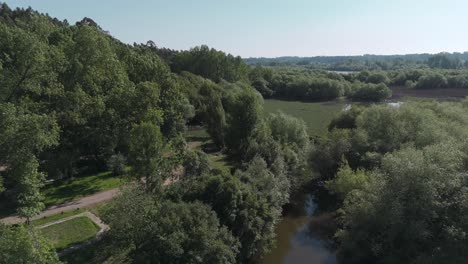 Aerial-view-of-a-dense-forest-area-and-water-bodies-in-Pateira-de-Fermentelos,-Aveiro,-Portugal