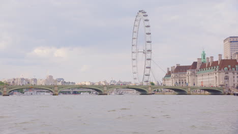 Iconic-London-Eye-ferris-wheel-on-bank-of-River-Thames-with-Westminster-Bridge