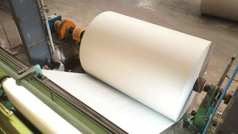 Paper-is-being-sold-through-a-paper-roll-machine-from-a-big-machine,-recycled-paper-manufacturing-fact