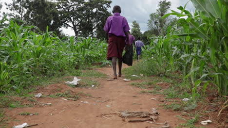 African-School-Children-Walking-To-School-In-Rural-Kampala-In-Uganda,-Africa