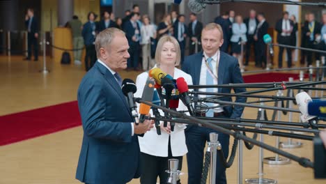 Polish-Prime-Minister-Donald-Tusk-talking-to-the-press-at-the-European-Council-summit-in-Brussels,-Belgium---Profile-shot