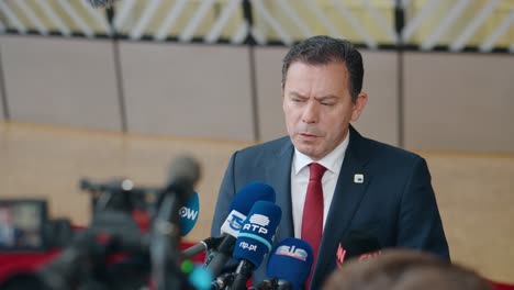 Prime-Minister-of-Portugal-Luis-Montenegro-talking-to-the-press-at-the-European-Council-summit-in-Brussels,-Belgium---Medium-shot