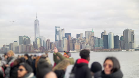 People-sightseeing-iconic-American-Manhattan-town,-view-on-Ferry-to-the-Statues-of-Liberty,-New-York