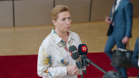 Danish-Prime-Minister-Mette-Frederiksen-talking-to-the-press-in-the-European-Council-building-during-EU-summit-in-Brussels,-Belgium---Medium-shot