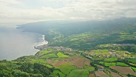 Miraduro-dos-picos-dos-bodes,-azores,-showcasing-lush-green-landscapes-and-coastline,-aerial-view