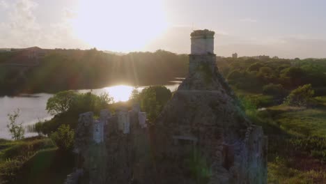 Sun-rays-cast-along-water-reflect-onto-Terryland-Castle-on-River-Corrib,-Galway-Ireland