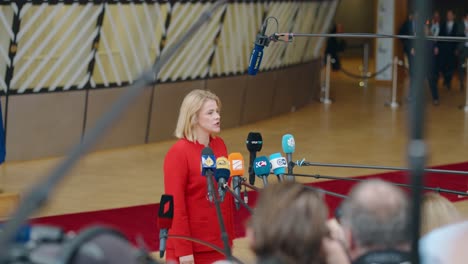 Latvian-Prime-Minister-Evika-Silina-talking-to-the-press-at-the-European-Council-summit-in-Brussels,-Belgium---Medium-shot,-slow-motion