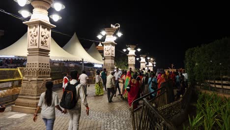 people-walking-at-temple-corridor-at-night-from-flat-angle-video-is-taken-at-mahakaleshwar-mahakal-temple-corridor-ujjain-madhya-pradesh-india-on-Mar-09-2024
