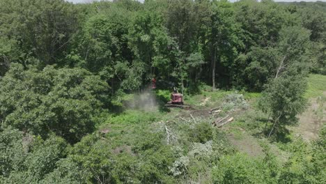 Rotating-drone-view-of-automated-machines-cutting-trees-and-destroying-the-nature