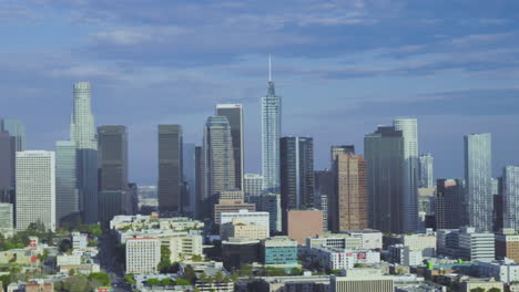 Panoramic-aerial-view-capturing-the-expansive-Los-Angeles-skyline,-offering-a-sweeping-vista-that-showcases-the-city's-iconic-landmarks-and-bustling-urban-landscape