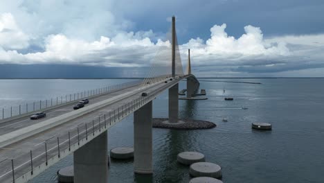 Drone-hyper-lapse-at-the-Sunshine-Skyway-Bridge-on-a-cloudy-day-with-stormy-clouds-in-the-distance