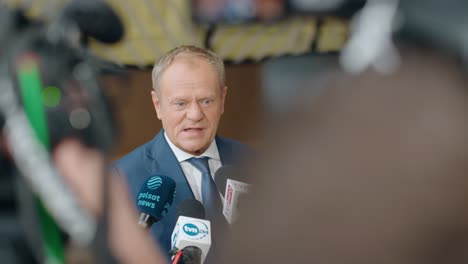 Polish-Prime-Minister-Donald-Tusk-talking-to-the-press-at-the-European-Council-summit-in-Brussels,-Belgium---Close-up,-slow-motion