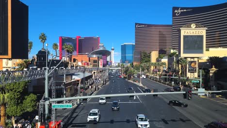 Traffic-on-Las-Vegas-Strip-on-Sunny-Day,-Cars-and-People-Between-Hotel-Casinos,-Nevada-USA