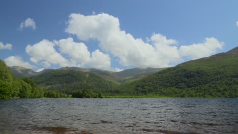 White-clouds-billowing-over-forested-mountainsides-next-to-lake-Ennerdale-Water-on-sunny-summer-day