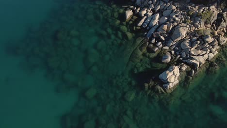 Lake-Tahoe-4k-Aerial-Drone-Video-of-Rocks-and-Teal-Blue-Water-in-Nevada-Northern-California-Birds-Eye-Top-Down-View