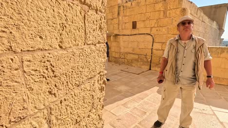 Traversing-the-fortress-walls-and-hallways-of-Gozo,-Malta,-people-and-travelers-explore-the-historical-site-on-a-sunny-day,-embodying-a-journey-through-ancient-history-and-cultural-richness