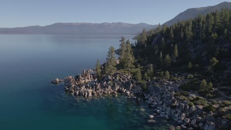 Lake-Tahoe-4K-Aerial-Drone-Footage-of-Rocks-and-Trees-on-Shoreline-of-Nevada-California