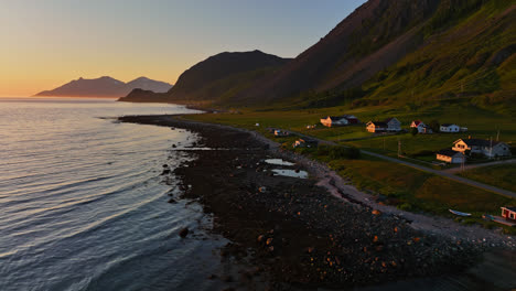 Aerial-view-over-a-camper-at-the-shore-of-Russelv,-sunset-in-Lyngen-alps,-Norway