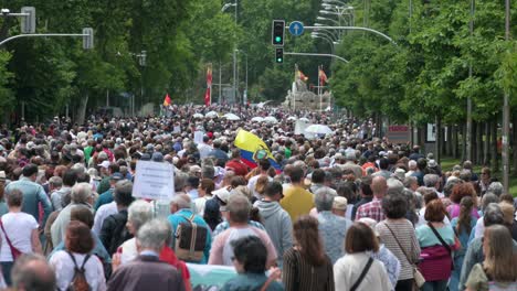 Marching-through-Madrid's-downtown,-thousands-of-protesters-defend-public-healthcare