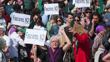 A-progressive-protester-shouts-slogans-as-they-hold-placards-during-a-demonstration-against-extreme-right-wing-and-fascist-movements-in-Europe,-urging-citizens-to-mobilize