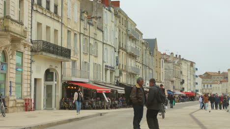 People-strolling-through-old-port-area-in-La-Rochelle,-France