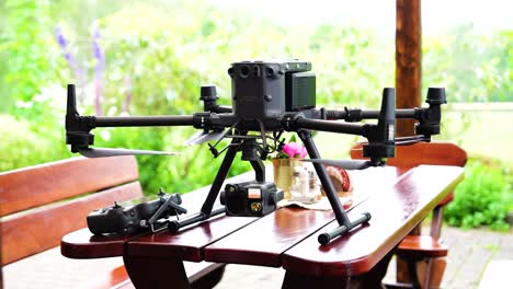 Large-industrial-drone-with-heavy-camera-payload-on-outdoor-wooden-table