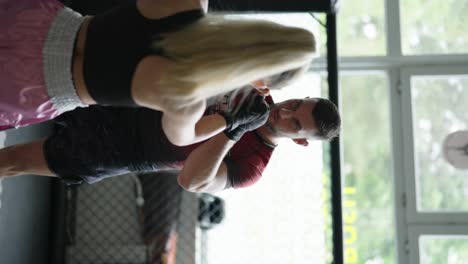 Vertical-view-of-combat-sport-fighters-touch-gloves-before-training-session