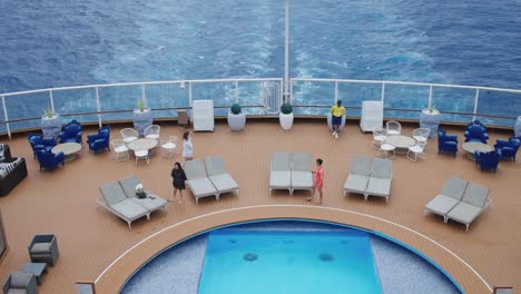 Top-View-Of-Upper-Deck-Private-Pool-On-Cruise-Ship-With-People-Enjoying-Summer-Vacation