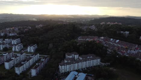 Slow-drone-shot-over-low-rise-buildings-during-sunset