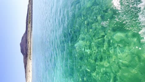 Vertical-video-Sailing-thru-the-sea-of-Cortez-looking-at-Coronado-Island,-beautiful-clear-turquoise-water