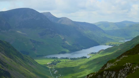 Cloud-shadows-moving-rapidly-over-deep-valley-floor-and-lake-Buttermere-next-to-mountain-High-Stile