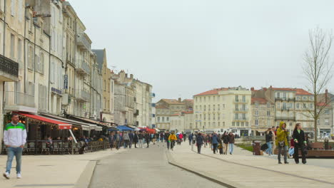 Rochelle-old-town-under-human-crowd-activity,-France