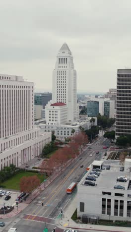 Vertical-Drone-Shot,-Los-Angeles-City-Hall,-Courthouse,-Hall-of-Justice,-Highway-and-Spring-Street-Traffic,-California-USA