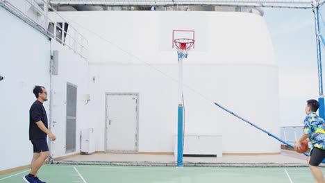 Father-And-Son-Playing-At-Upper-Deck-With-Mini-Basketball-Court-At-Cruise-Liner-Or-Ship