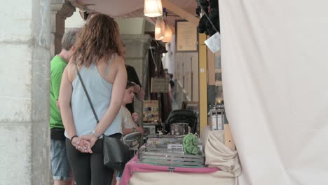 Group-of-people-shopping-at-a-medieval-market-stall