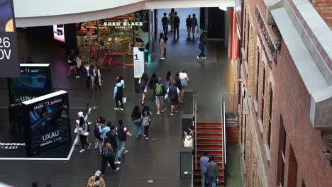 Shoppers-and-commuters-entering-and-exiting-Melbourne-Central,-a-shopping-and-commercial-precinct-in-downtown-area,-showcasing-the-hustle-and-bustle-of-urban-lifestyle