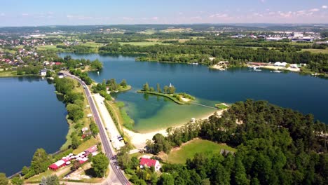 Twin-lakes-of-Kryspinów-Reservoir-with-sandy-beaches,-and-lush-greenery-at-Budzyn,-Poland
