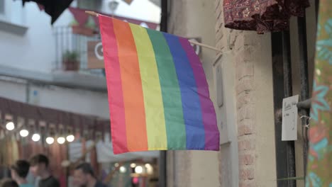 Gay-pride-flag-waving-at-a-medieval-marketplace