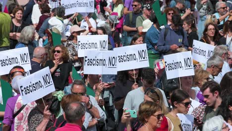 Progressive-protesters-hold-placards-during-a-demonstration-against-extreme-right-wing-and-fascist-movements-in-Europe,-urging-citizens-to-mobilize