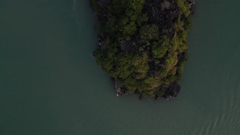 drone-shot-of-boat-floating-past-green-islands-in-Cat-Ba-and-Halong-Bay-in-Northern-Vietnam